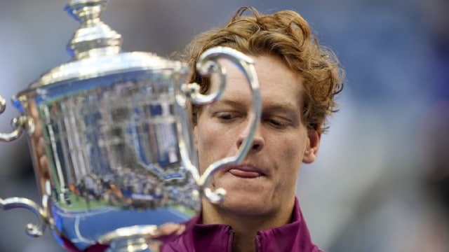 Jannik Sinner, of Italy, holds up the championship trophy after defeating Taylor Fritz, of the United States, in the men's singles final of the U.S. Open tennis championships, Sunday, Sept. 8, 2024, in New York. (AP Photo)