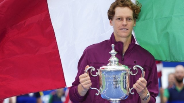 Jannik Sinner, of Italy, holds up the championship trophy after defeating Taylor Fritz, of the United States, in the men's singles final of the U.S. Open tennis championships, Sunday, Sept. 8, 2024, in New York. (AP Photo)