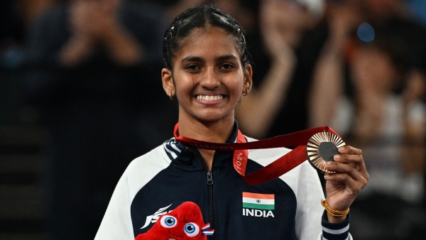 Bronze medallist Manisha Ramadass celebrates on the podium 