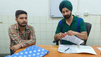 a doctor stapling pamphlet with OPD slips