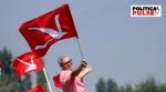 Omar Abdullah, Vice President of the Jammu and Kashmir National Conference (JKNC) and former Chief Minister of Jammu and Kashmir, poses with his party's flag in the waters of Dal Lake during an election campaign in the lake, in Srinagar