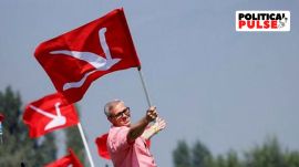 Omar Abdullah, Vice President of the Jammu and Kashmir National Conference (JKNC) and former Chief Minister of Jammu and Kashmir, poses with his party's flag in the waters of Dal Lake during an election campaign in the lake, in Srinagar