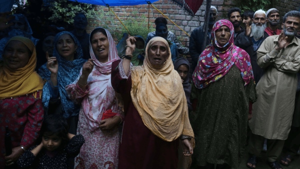 Several women gathered around Itoo tell her about their sons who have been incarcerated for a long period.