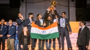 Viswanathan Anand (right) watches on as Indian men team celebrates at the podium after winning 2024 Chess Olympiad. (Michal Walusza | FIDE)