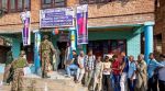 Voters stand in a queue at a polling station to cast votes during the second phase of Jammu and Kashmir Assembly elections, in Srinagar district