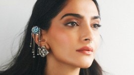 Sonam Kapoor stuns in a gothic-inspired Dior ensemble at Paris Fashion Week.