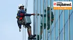 A worker cleaning glass.