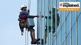 A worker cleaning glass.