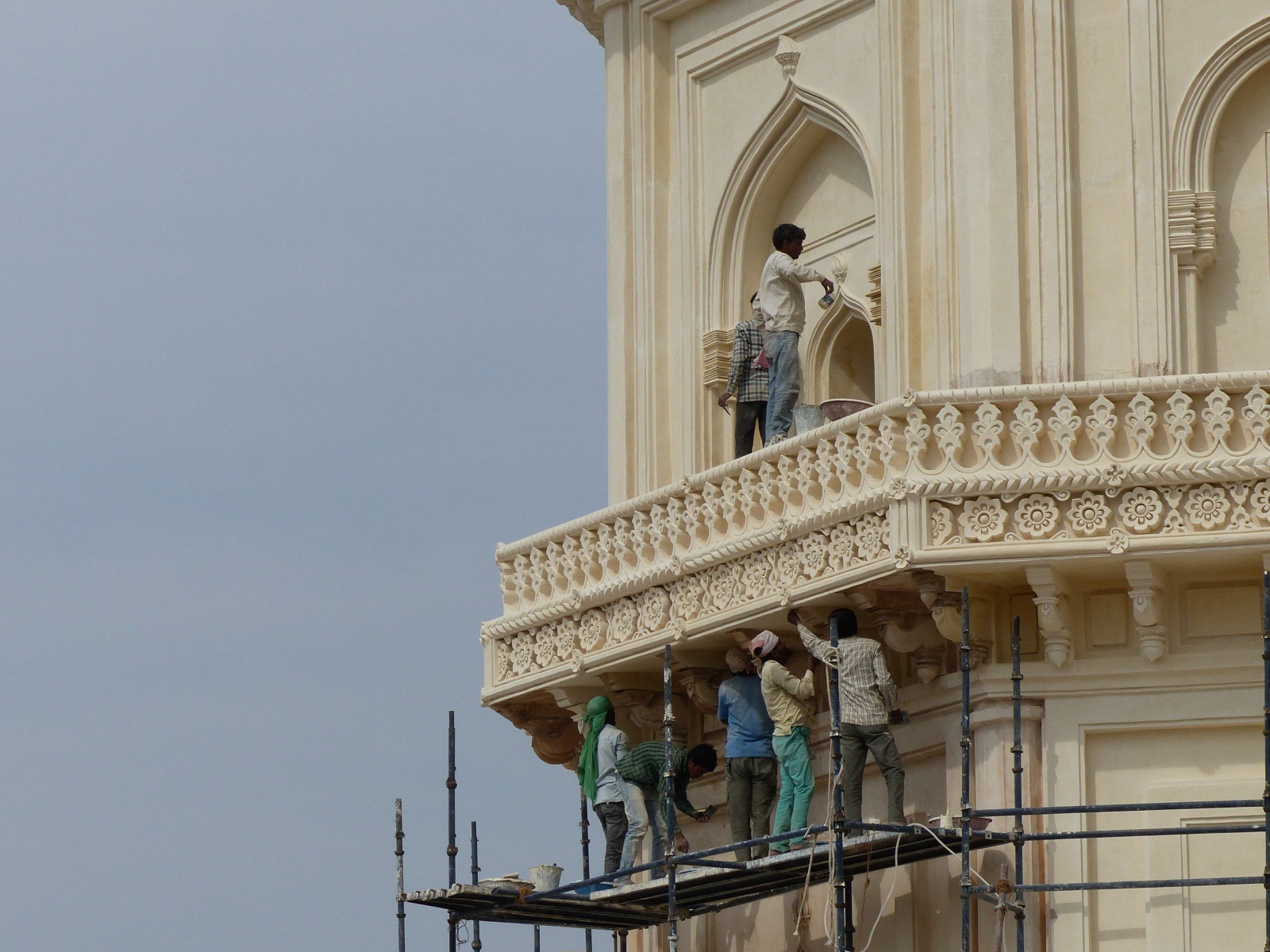 Craftsmen working on punning the external facade of the tomb. (Express Photo)
