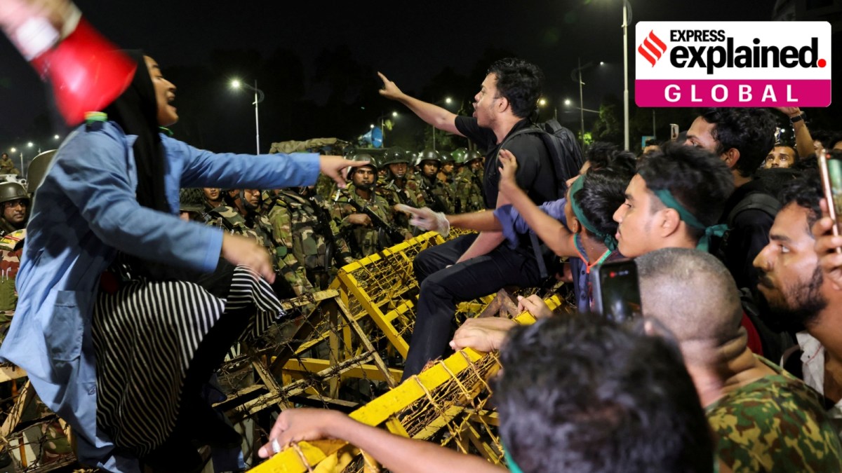 Protesters sit on the barricade placed in front of the Bangabhaban, the residence and workplace of the President, as they shout slogans demanding the resignation of President Mohammed Shahabuddin in Dhaka