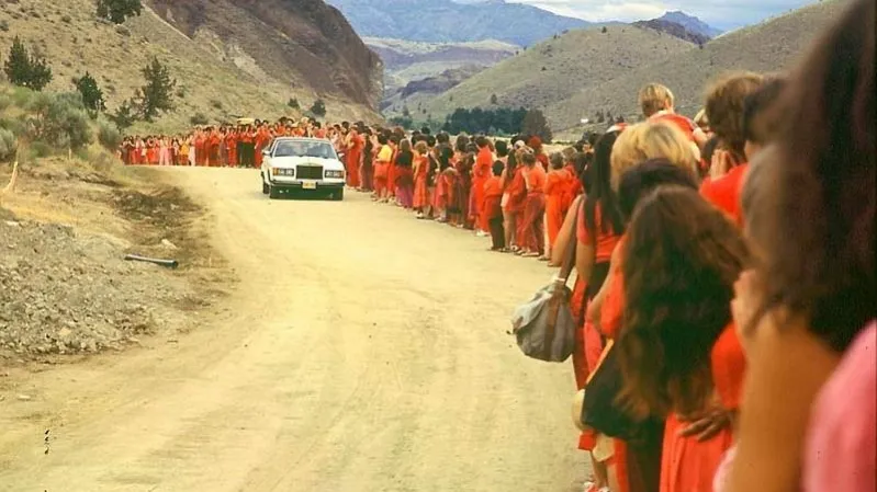 Bhagwan Shree Rajneesh drives by his followers astatine  Rajneeshpuram successful  1  of his galore  Rolls Royces successful  1982 (Samvado Gunnar Kossatz, Wikimedia Commons)