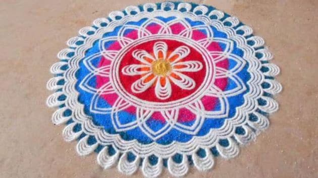 Drawing rangoli patterns is believed to invite positive energy into the home, making it an essential part of the Diwali festivities. (Source: Canva)