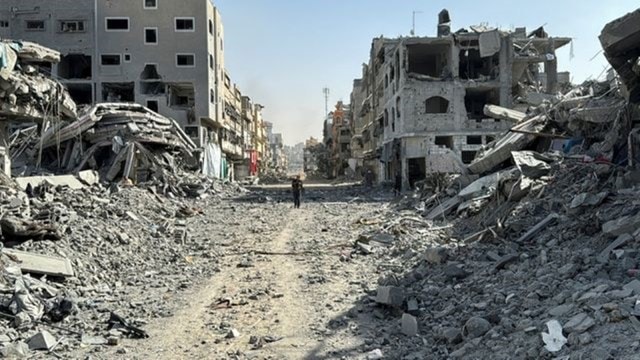 A Palestinian antheral   walks past   the rubble aft  Israeli forces withdrew from the country  astir   Kamal Adwan hospital, amid the ongoing Israel-Hamas conflict, successful  Jabalia, successful  the bluish   Gaza Strip