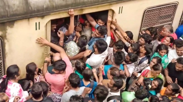 Passengers board a train at the Velachery railway station to depart for an air show on the 92nd Indian Air Force (IAF) Day at the Marina Beach, in Chennai, Sunday, Oct. 6, 2024.