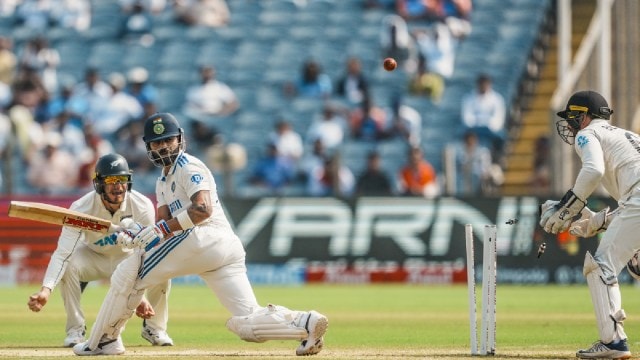 India's Virat Kohli being bowled by New Zealand's Mitchell Santner on the second day of the second test cricket match between India and New Zealand, at the Maharashtra Cricket Association Stadium, in Pune,