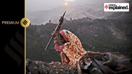 A worker chips away at a seam of coal as she scavenges at an open-cast mine in the village of Bokapahari in the eastern Indian state of Jharkhand.