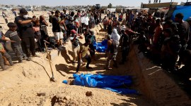 Unidentified bodies of Palestinians killed in Israel's military offensive being buried in a mass grave in Khan Younis. (Reuters file)