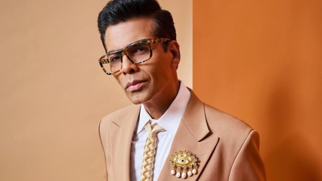 Karan paired his suit   with a surreal braided-hair necktie  from Schiaparelli's Autumn-Winter 2024 collection, showcased astatine  Paris Fashion Week.