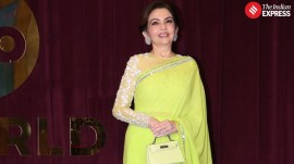 Nita Ambani makes a bold statement in a neon green sari at the launch of Manish Malhotra's new store. (Source: Varinder Chawla)