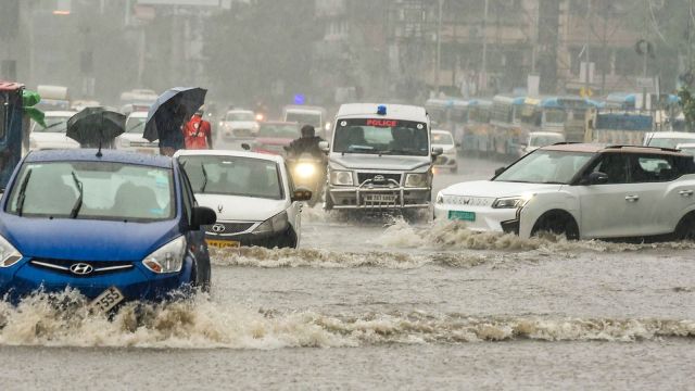 Vehicles move on a waterlogged road during rain in the aftermath of Cyclone ‘Dana’, in Kolkata, Friday, Oct. 25, 2024. (PTI Photo)