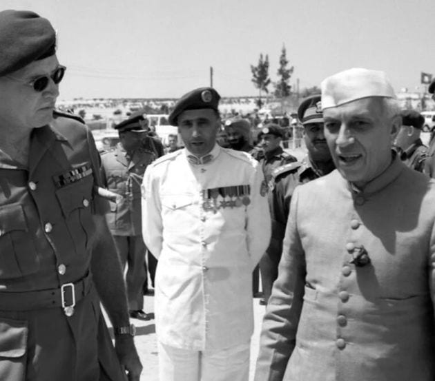 Jawaharlal Nehru is seen here being greeted by Colonel ER Heuchan upon his arrival at the UNEF Maintenance Area during his visit to UNEF troops in Gaza in May 1960. Lieutenant-General PS Gyani, UNEF Commander, is standing between the two men."