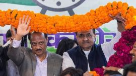 NCP chief Ajit Pawar (left) with party leader Praful Patel being garlanded by supporters during his visit to the party office, in New Delhi, on Thursday. (PTI Photo)