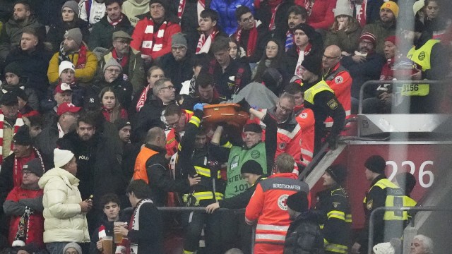 Police officers and paramedics carry a stretcher down the stands during a medical emergency during the Champions League opening phase soccer match between Bayern Munich and SL Benfica, in Munich, Germany, Wednesday, Nov. 6, 2024. (AP Photo)