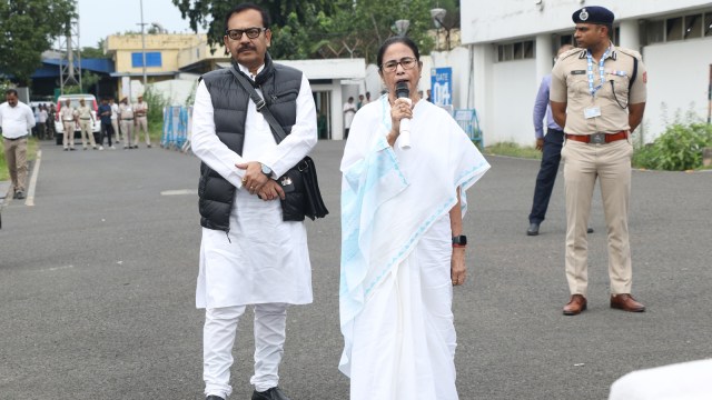Chief Minister Mamata Banerjee with Sports Minister Arup Biswas at the Kolkata airport before heading to Darjeeling on Monday. (Express Photo)