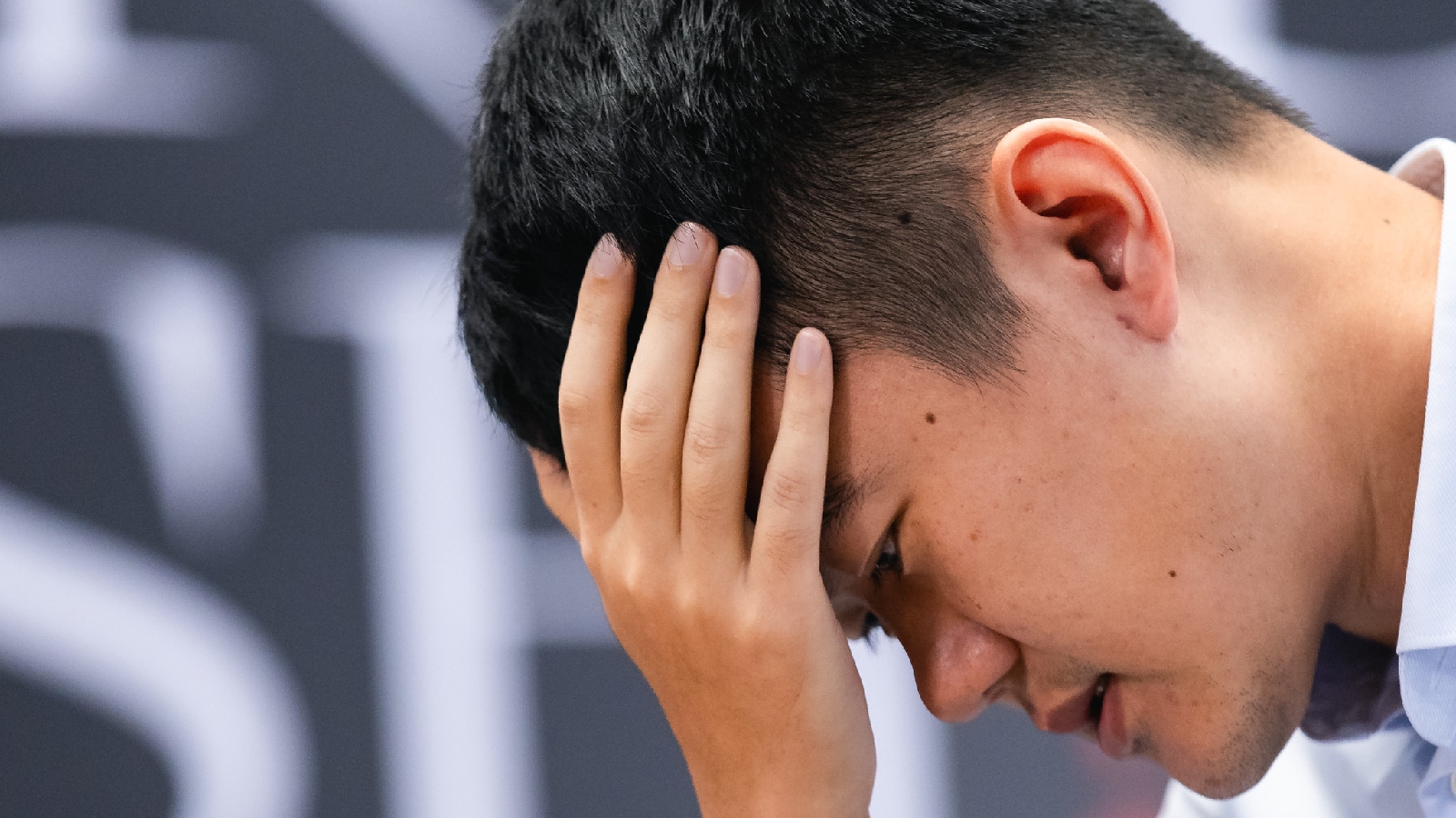 Ding Liren reacts during game 3 of the World Chess Championship against Gukesh. (FIDE via Eng Chin An)