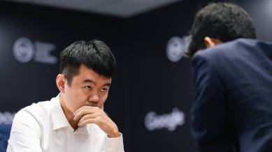 Ding Liren sneaks a glance at Gukesh in game 4 of the World Chess Championship in Singapore. (PHOTO: FIDE/Eng Chin An)