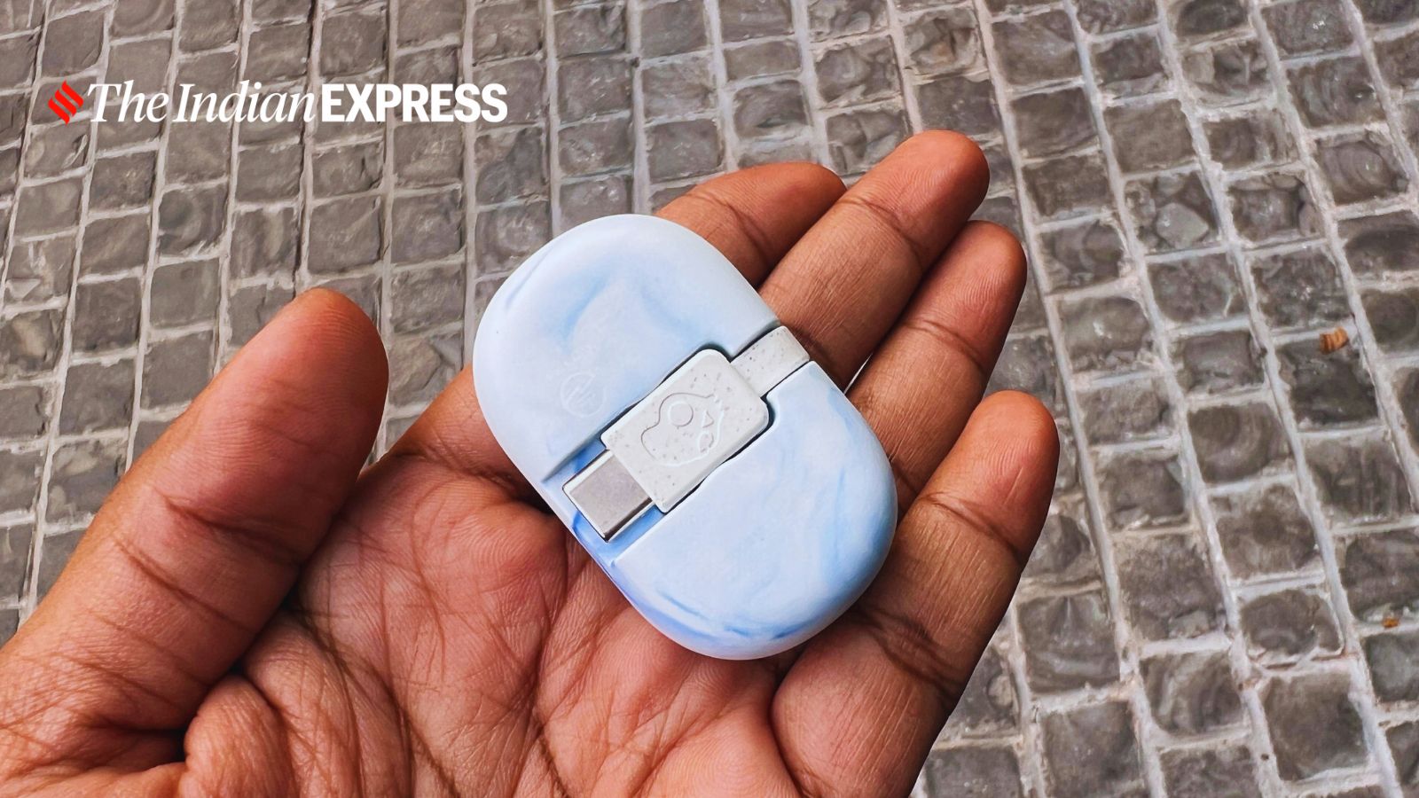 The most striking aspect of the Skullcandy earbuds is the connector with its tiny cable clasped to its case without lid. (Image: Bijin Jose/The Indian Express)