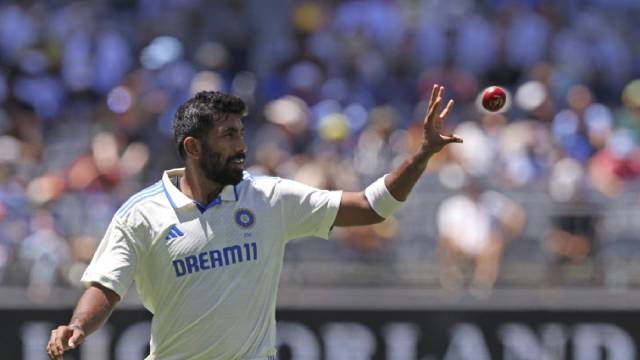 India's captain Jasprit Bumrah collects the ball as he prepares to bowl on the second day of the first cricket test between Australia and India in Perth. (AP)