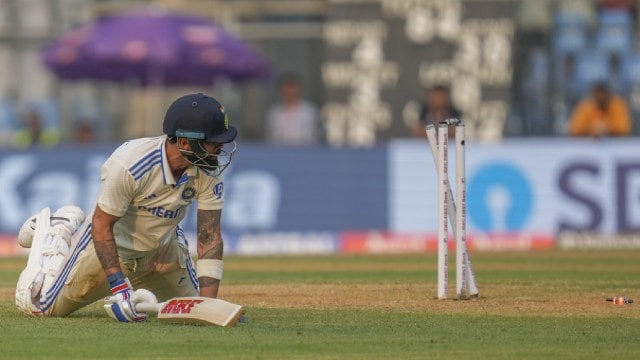 India's Virat Kohli dives in vain to prevent being run out by New Zealand's Matt Henry during the first day of the third Test at Wankhede Stadium, in Mumbai. (AP Photo)