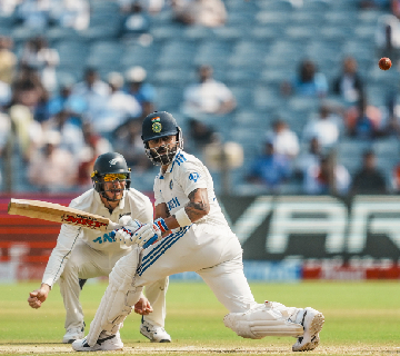 India's Virat Kohli being bowled by New Zealand's Mitchell Santner on the second day of the second test cricket match between India and New Zealand, at the Maharashtra Cricket Association Stadium, in Pune,