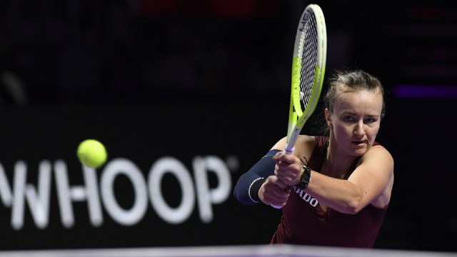 Czech Republic's Barbora Krejcikova, in action with China's Qinwen Zheng during women's singles semi final match at King Saud University Indoor Arena, in Riyadh, Saudi Arabia, Friday, Nov. 8, 2024. (AP Photo)