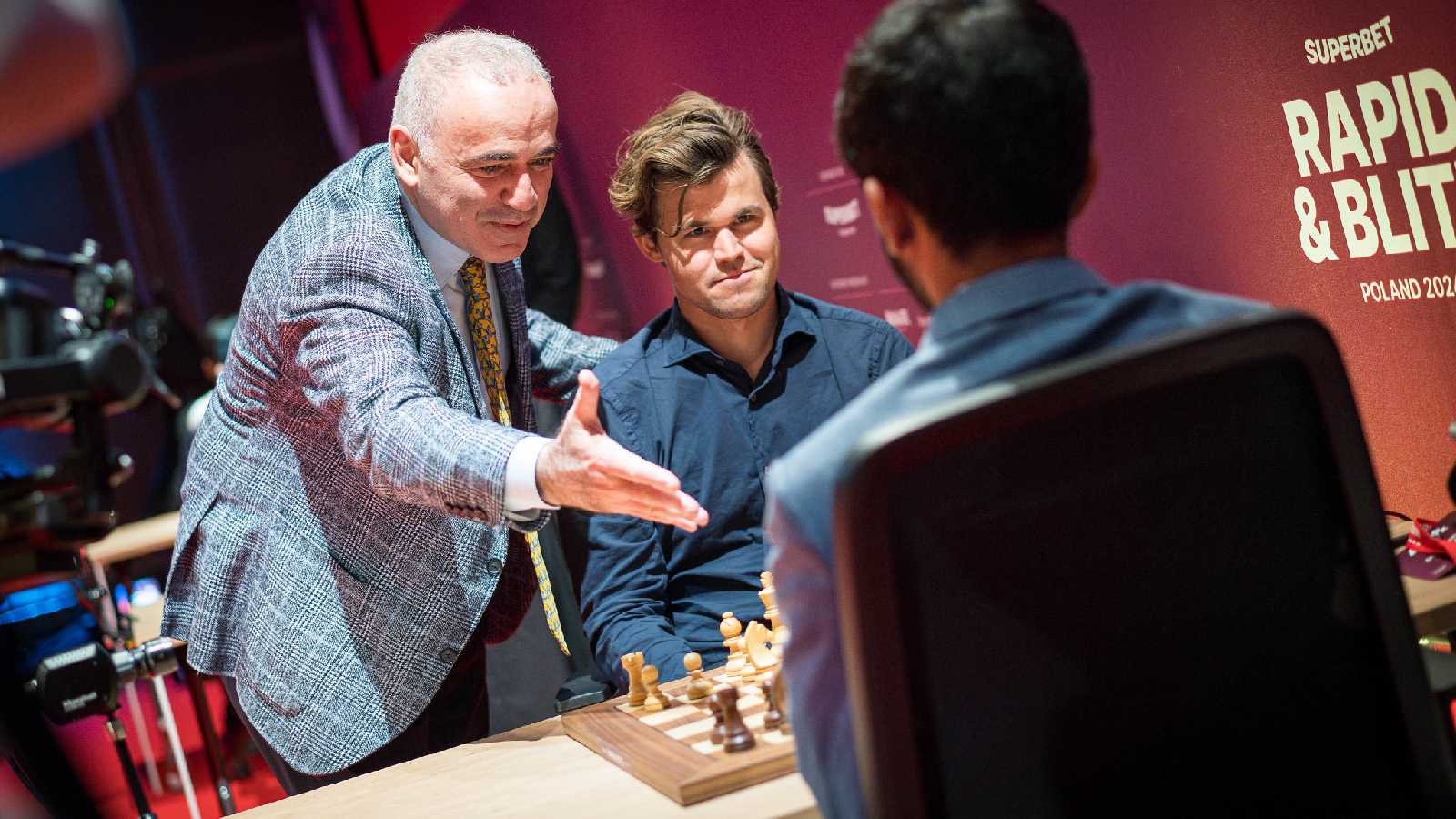 Garry Kasparov (left) greets Gukesh (right) before the teenager's match against Magnus Carlsen earlier this year at the Superbet Rapid & Blitz Poland tournament. (Photo Courtesy Lennart Ootes)