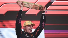 Red Bull driver Max Verstappen, of the Netherlands, celebrates on the podium his first place in the Brazilian Formula One Grand Prix at the Interlagos race track in Sao Paulo, Sunday, Nov. 3, 2024. (AP Photo)