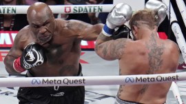Mike Tyson lands a left to Jake Paul during their heavyweight boxing match. (AP)