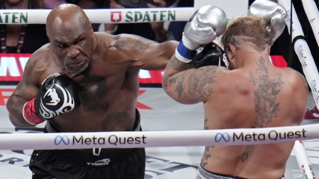 Mike Tyson lands a left to Jake Paul during their heavyweight boxing match. (AP)