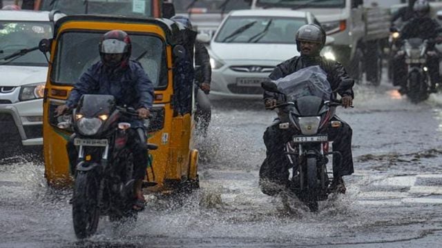 Commuters wade done  a flooded thoroughfare  amid rains, successful  Chennai.