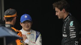 Mercedes' George Russell (right), who is a director at the Grand Prix Drivers' Association, talks to RB driver Yuki Tsunoda (center) and McLaren driver Lando Norris after qualifying session for the Brazilian Formula One Grand Prix. (AP Photo)