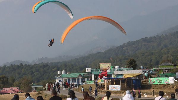 Tourists watch paragliders at the landing site in Bir in Himachal Pradesh. Kamleshwar Singh