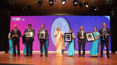 Finance Minister Nirmala Sitharaman releases commemorative coins during centenary celebration of the main branch of State Bank of India in Mumbai on Monday.