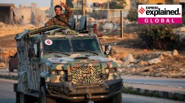 A rebel led by the Islamist militant group Hayat Tahrir al-Sham stands in the back of a vehicle in al-Rashideen, Aleppo province, Syria November 29, 2024.