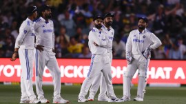 Indian players wait after the floodlights went off during the day one of the second cricket test match between Australia and India at the Adelaide Oval in Adelaide, Australia. (AP)