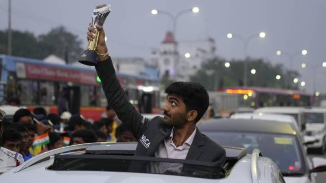 Gukesh Dommaraju poses with trophy during a procession held to honor him on becoming the World youngest chess champion in Chennai, India, Tuesday, Dec. 17, 2024. (AP Photo)