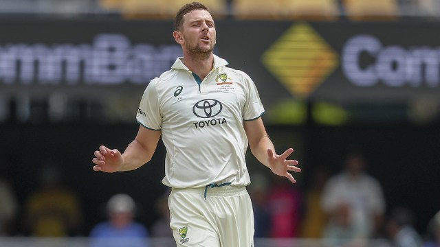 Australia's Josh Hazlewood reacts after bowling a delivery during play on day three of the third cricket test between India and Australia at the Gabba in Brisbane, Australia, Monday, Dec. 16, 2024. (AP Photo)