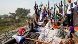 Punjab Farmers block railway tracks as part of their state-wide 'Rail Roko' protest to press the Centre into accepting their various demands, including a legally binding minimum support price for crops, on the outskirts of Amritsar, Wednesday. (PTI Photo)