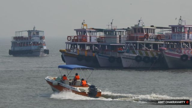 People wearing life vests while boating near Gateway of India off the Mumbai coast on Friday. Two days ago, a Navy speedboat crashed into a private ferry, killing at least 14 people in the area. (Express Photo)