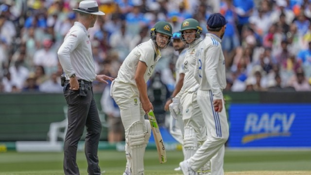 India's Virat Kohli, right, talks to Australia's Sam Konstas, second left, as Australia's Usman Khawaja, looks on during play on the first day of the fourth cricket test between Australia and India at the Melbourne Cricket Ground, Melbourne, Australia. (AP)